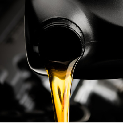 Pouring oil motor car  lubricant  from black bottle on engine background , service oil change auto repair shop